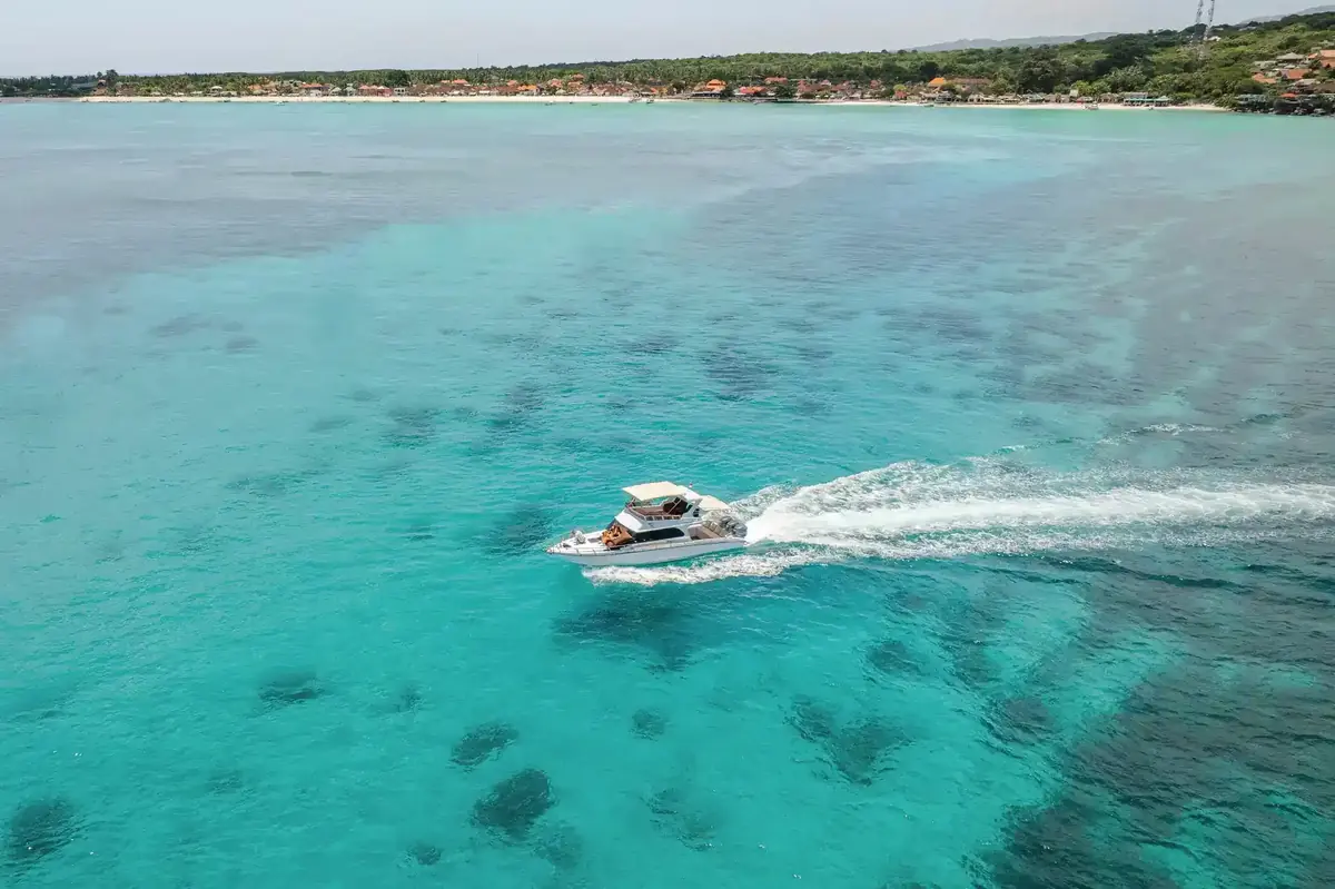 A motor yacht crossing calm, sheltered shallows