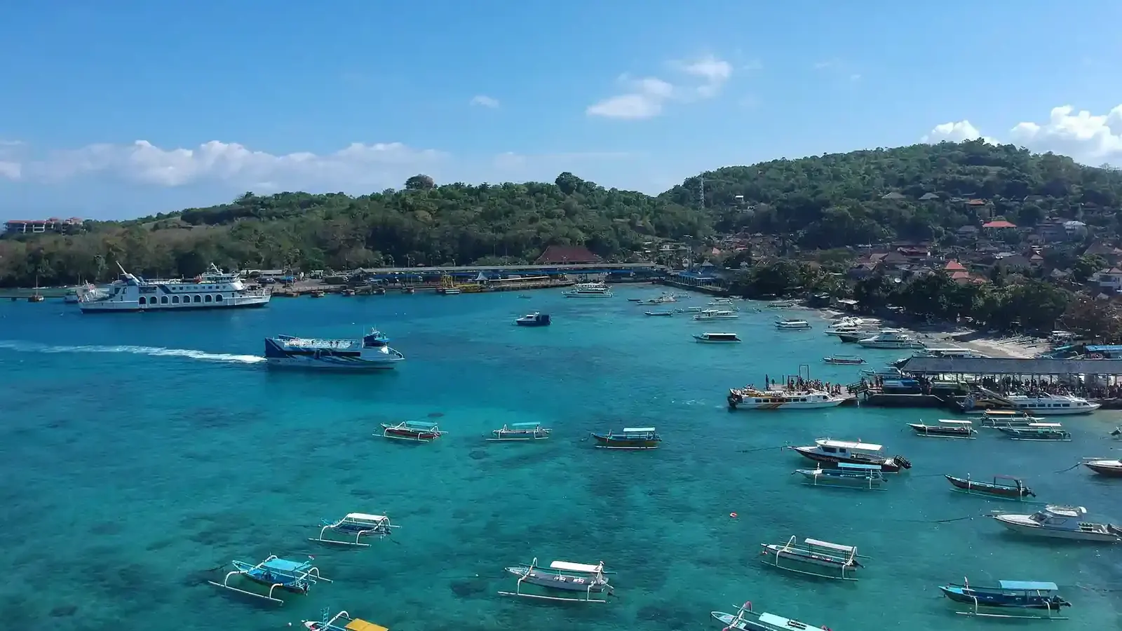 Boats moored in a busy harbour on the Bali coast