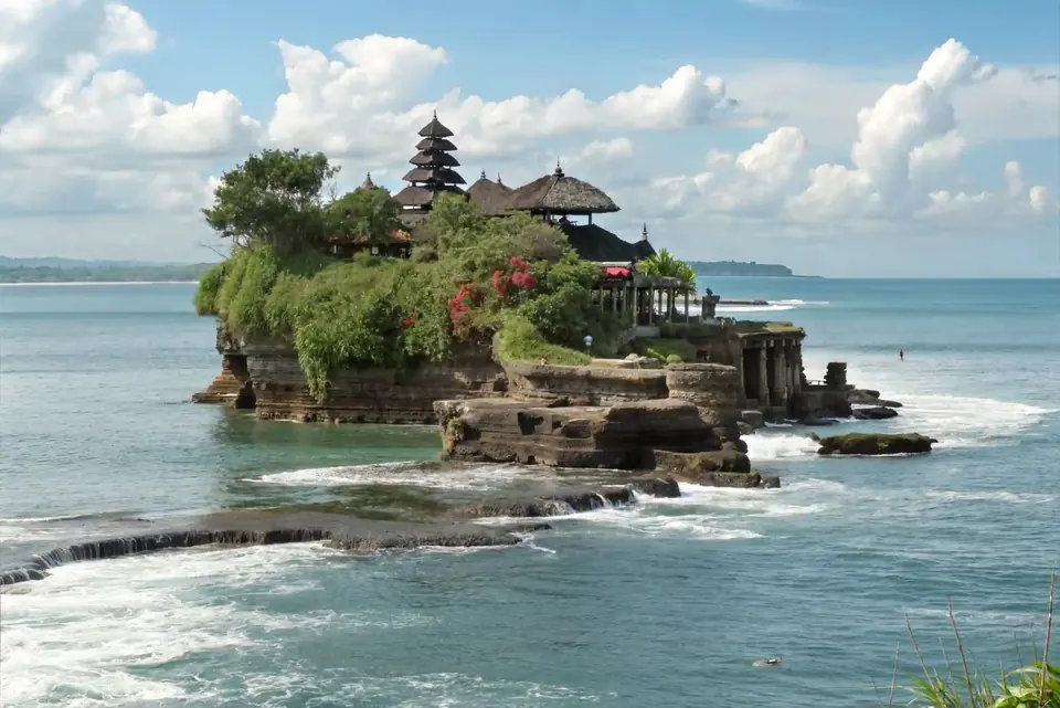 Tanah Lot sea temple on its rock outcrop, surrounded by surf
