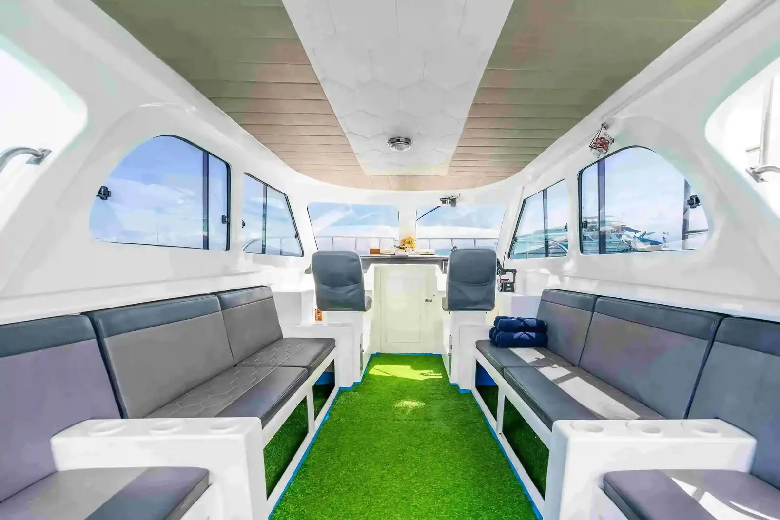 The cabin of a speedboat with cushioned bench seating