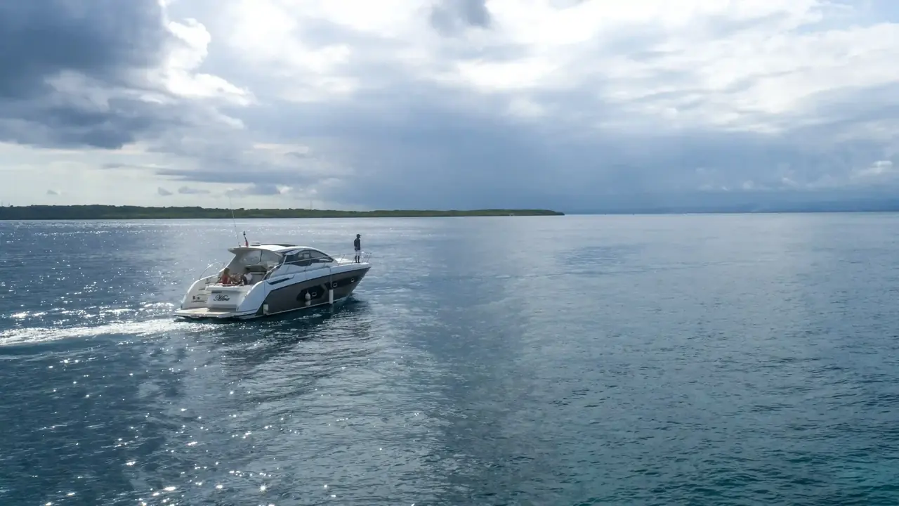 A white sport yacht under way on calm water
