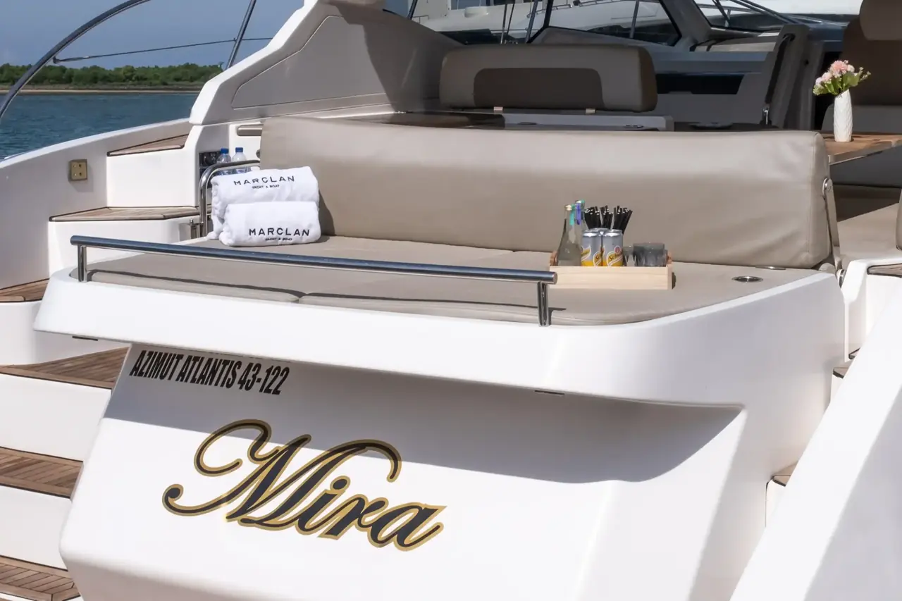 The stern and aft deck of a white sport yacht