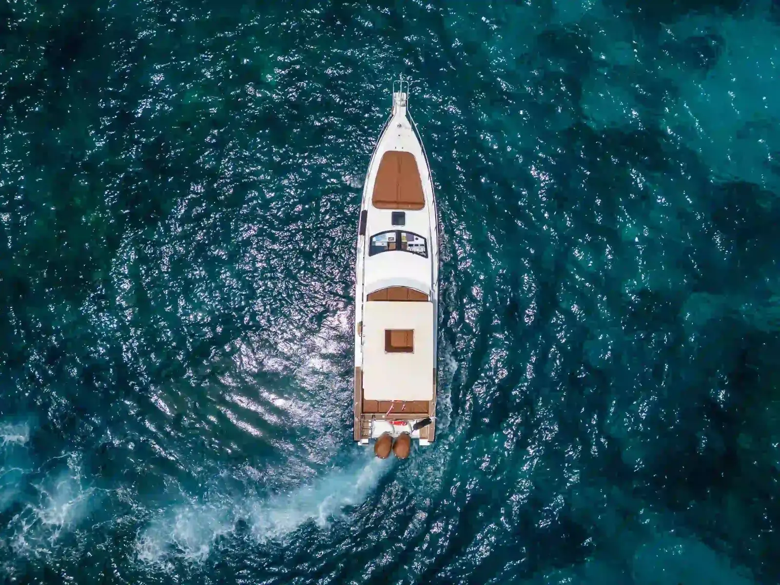 A charter yacht at anchor seen from above