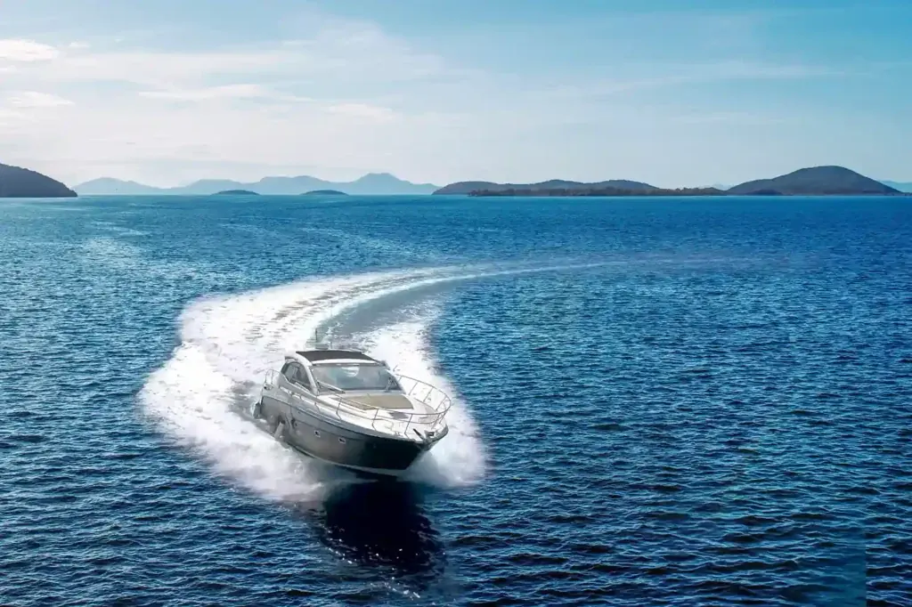 A sport yacht leaving a curved wake across blue water