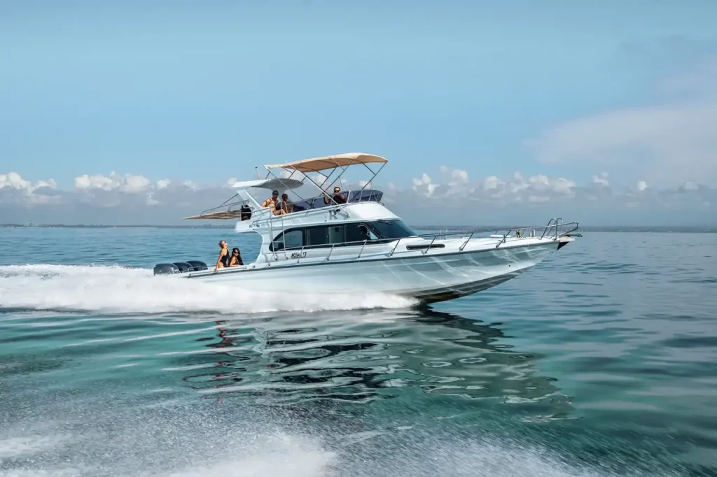 Guests on the flybridge of a motor yacht under way