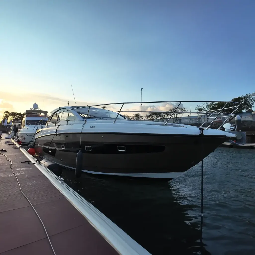 A motor yacht moored at a marina pontoon