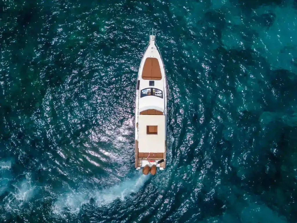 A charter yacht at anchor seen from directly above